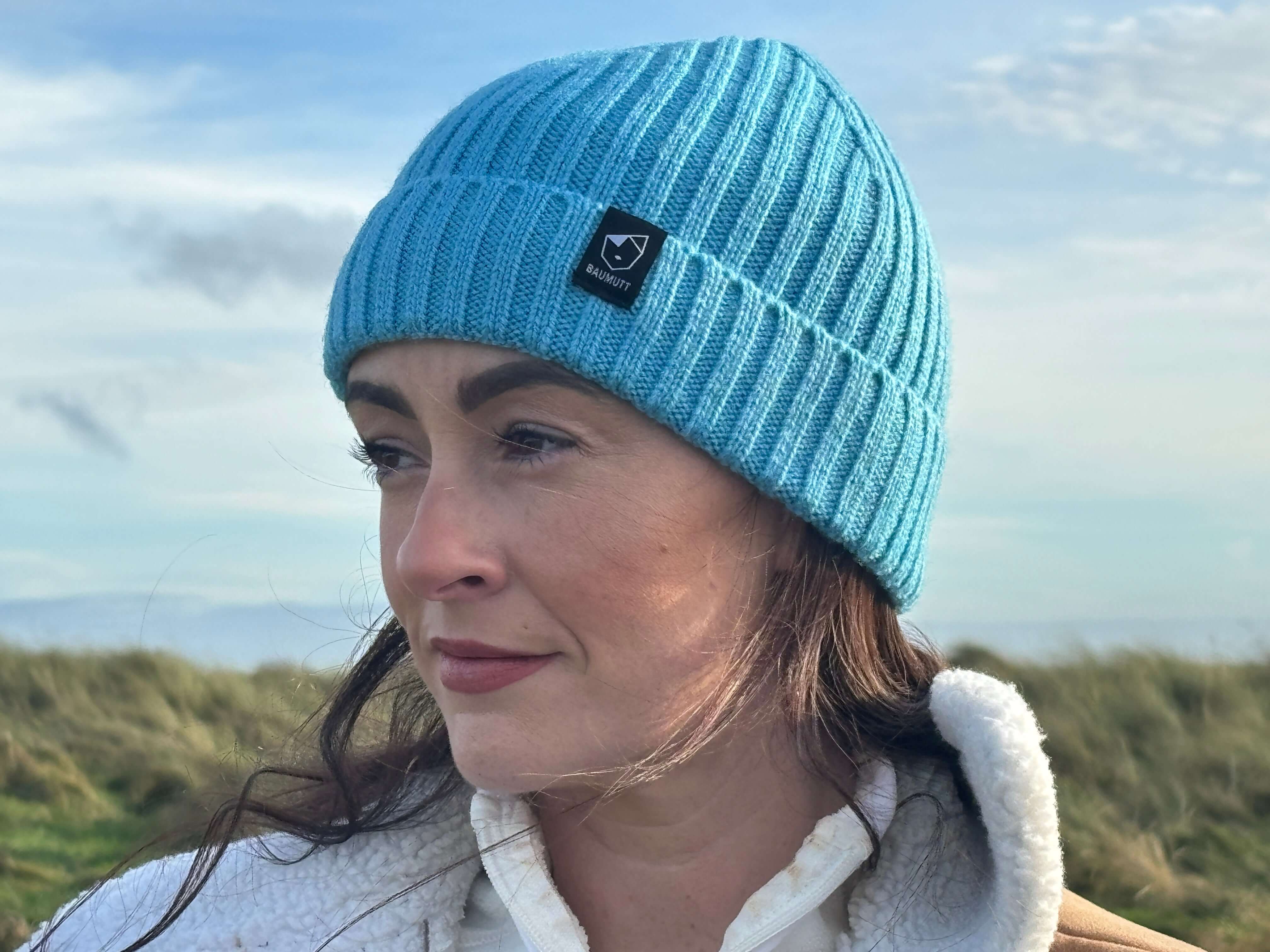 Fisherman Beanie hat by BAUMUTT, female model side profile in aqua blue colour