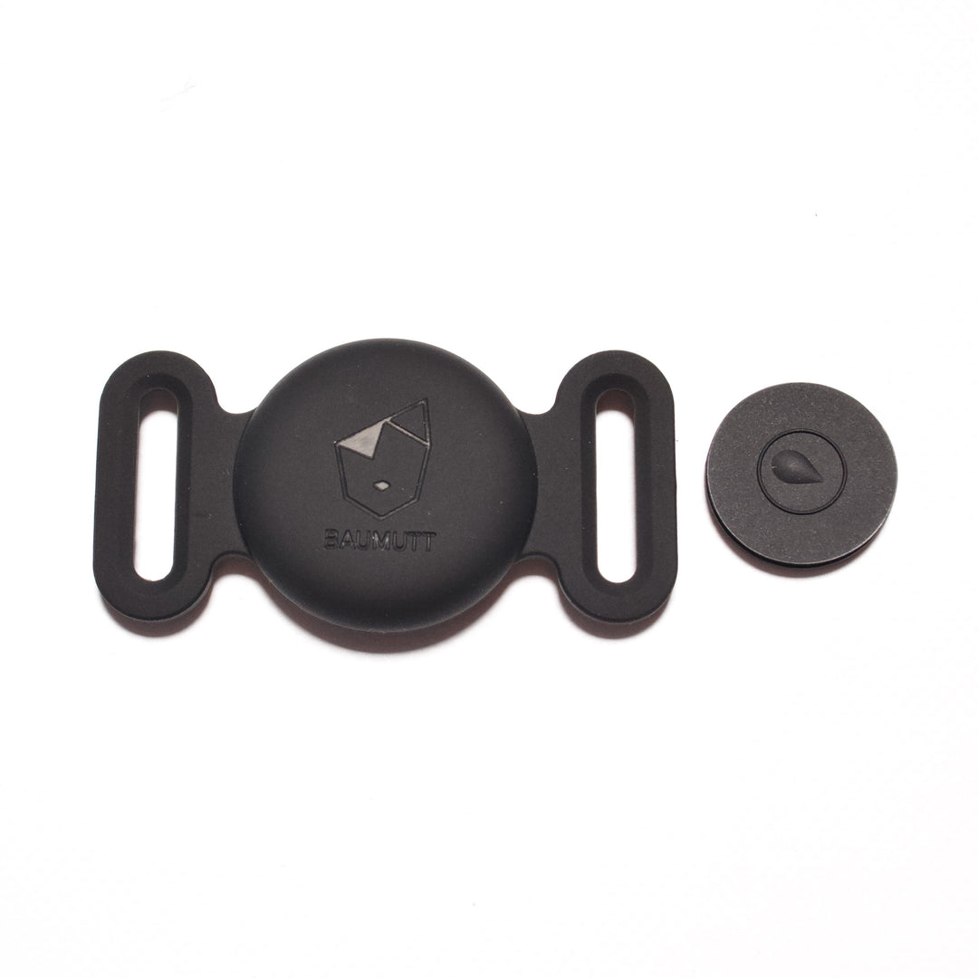 Black Apple AirTags dog collar holder, with BAUMUTT logo on the front. Flat front view with closing piece taken out and in view